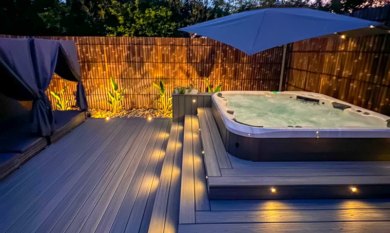 beautiful decking with recessed lights around an outdoor spa pool at night using trex components